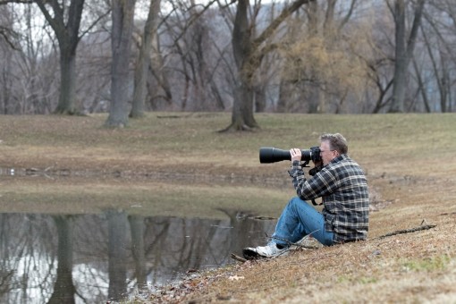 A student works on getting lower to photograph his subject